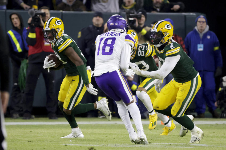 Green Bay Packers safety Adrian Amos (31) runs from Minnesota Vikings wide receiver Justin Jefferson (18) after intercepting a pass during the first half of an NFL football game, Sunday, Jan. 1, 2023, in Green Bay, Wis. (AP Photo/Mike Roemer)