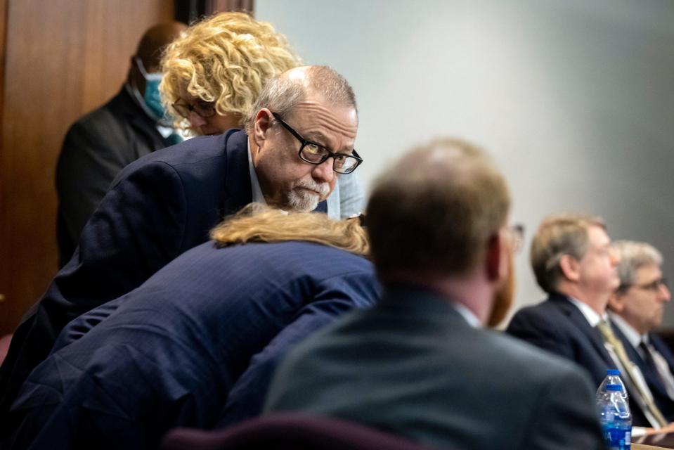 Greg McMichael takes his seat after Superior Court Judge Timothy Walmsley at the Glynn County Courthouse, Wednesday, Nov. 24, 2021, in Brunswick, Ga.