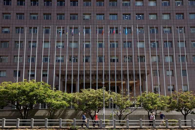 People walk past the Diplomatic Quarter, which houses the Honduras embassy among others, in Taipei