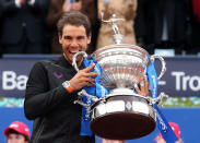 Tennis - Barcelona Open Final - Rafael Nadal of Spain v Dominic Thiem of Austria - Real Club de Tenis Barcelona, Spain - 30/04/17 - Rafael Nadal bites the trophy. REUTERS/Albert Gea