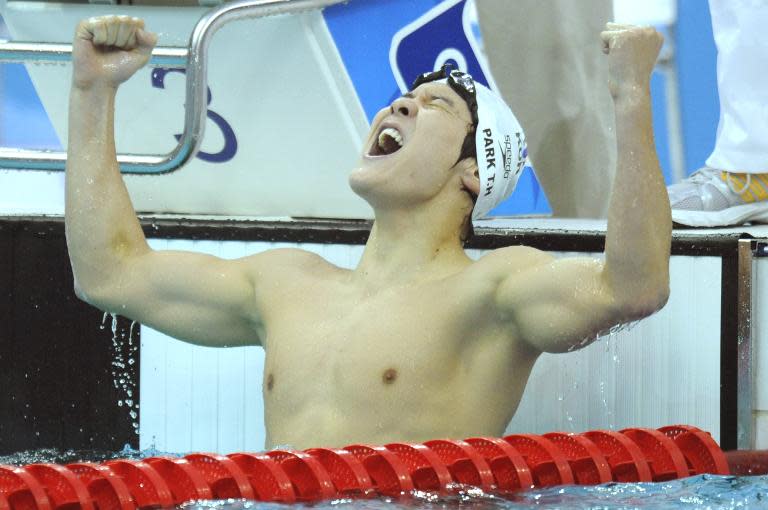 South Korea's Park Tae-Hwan celebrates after winning the men's freestyle swimming final at the Beijing Olympic Games on August 10, 2008