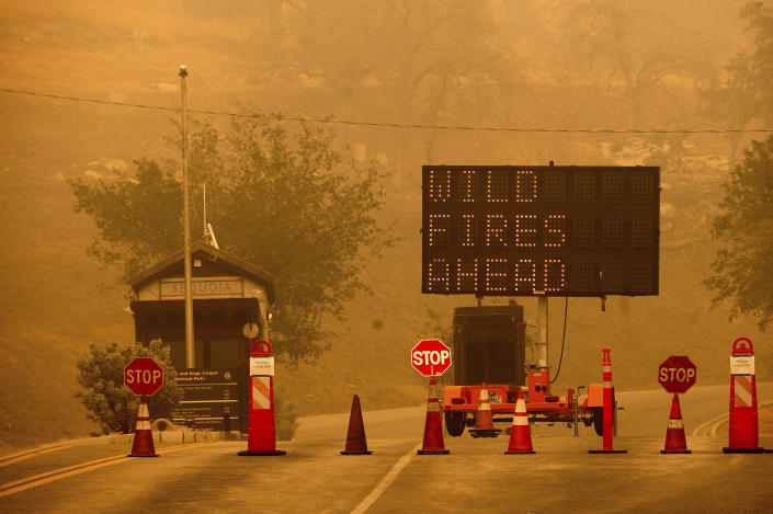 Cones block the entrance to Sequoia National Park, Calif., as the KNP Complex Fire burns nearby on Wednesday, Sept. 15, 2021. The blaze is burning near the Giant Forest, home to more than 2,000 giant sequoias. (AP Photo/Noah Berger)