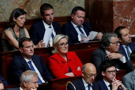 FILE PHOTO: Members of parliament Marine Le Pen, Louis Aliot, Emmanuelle Menard, Gilbert Collard, Ludovic Pajot, Bruno Bilde and Sebastien Chenu of France's far-right National Front (FN) political party listen to the speech of French Prime Minister Edouard Philippe on the government general policies plans at the National Assembly in Paris, France, July 4, 2017. REUTERS/Philippe Wojazer/File Photo