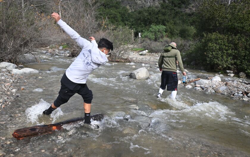 Pasadena, California January 12, 2023-A hiker slips in a creek in Eaton Canyon as recent storms have caused mudslides on local hiking trails. (Wally Skalij/Los Angeles Times)