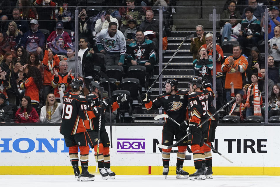 Anaheim Ducks center Mason McTavish, third from left, is congratulated by teammates after he scored against the Montreal Canadiens during the second period of an NHL hockey game Wednesday, Nov. 22, 2023, in Anaheim, Calif. (AP Photo/Ryan Sun)