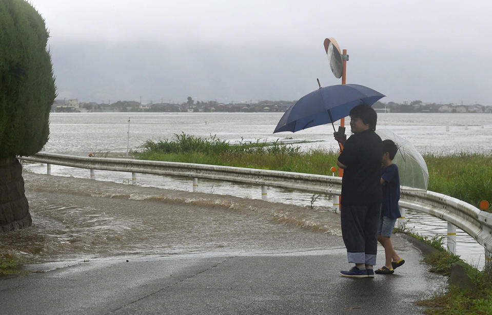 A road in Tachiarai in Fukuoka Prefecture is submerged as a river is swollen due to heavy rain. Source: Kyodo via AP
