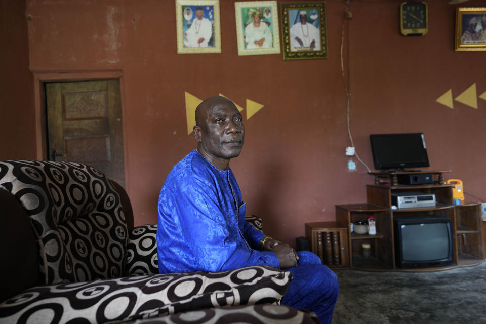 Patrick Aganyebi, a maintenance operator aboard the Trinity Spirit oil ship, sits for a portrait in his home in Igbokoda, Nigeria, on Tuesday, Sept. 6, 2022. It was the dead of night when the Trinity Spirit caught fire, Aganyebi remembers, but the flames made it seem as bright as day. Months afterward, his eyes were still damaged from the glare. He tucked his phone and ID card in his pockets, strapped on a life jacket and made his way to the upper deck, and as the flames barreled toward him, prepared to jump nearly 100 feet (30 meters) into the sea. (AP Photo/Sunday Alamba)