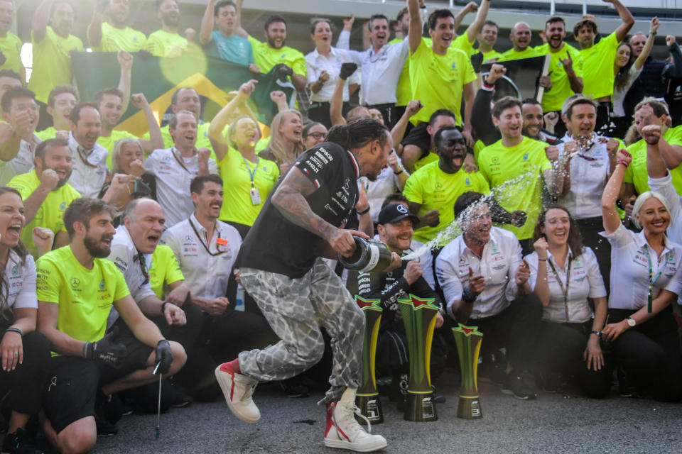 Mercedes' British driver Lewis Hamilton celebrates with his team after winning Brazil's Formula One Sao Paulo Grand Prix at the Autodromo Jose Carlos Pace, or Interlagos racetrack, in Sao Paulo, on November 14, 2021. (Photo by NELSON ALMEIDA / AFP) (Photo by NELSON ALMEIDA/AFP via Getty Images)