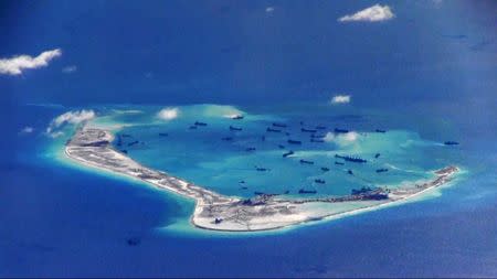 FILE PHOTO - Chinese dredging vessels are purportedly seen in the waters around Mischief Reef in the disputed Spratly Islands in the South China Sea in this still image from video taken by a P-8A Poseidon surveillance aircraft provided by the United States Navy May 21, 2015. U.S. Navy/Handout via Reuters/Files