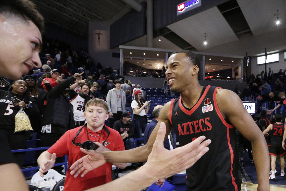 San Diego State guards Micah Parrish, right, and Miles Byrd celebrate the team's 84-74 win against Gonzaga after an NCAA college basketball game, Friday, Dec. 29, 2023, in Spokane, Wash. (AP Photo/Young Kwak)