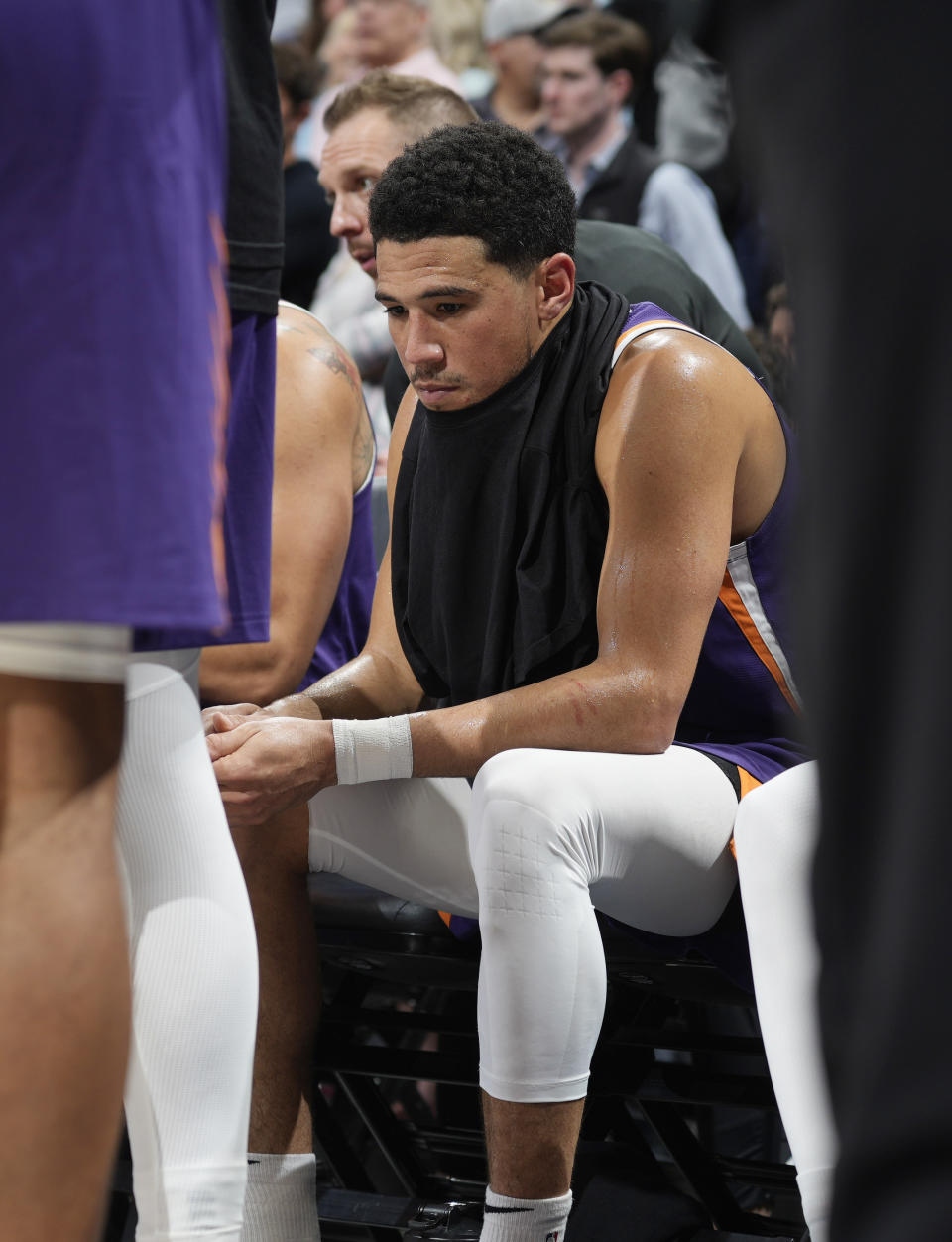 Phoenix Suns guard Devin Booker sits on the bench late in the second half of Game 5 of the team's NBA Western Conference basketball semifinal playoff series against the Denver Nuggets on Tuesday, May 9, 2023, in Denver. (AP Photo/David Zalubowski)