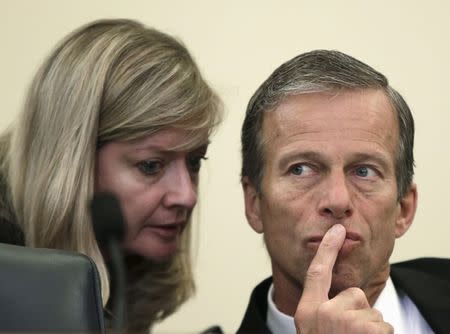 The chair of the Senate Commerce, Science and Transportation committee, Senator John Thune (R-SD) (R) listens to an aide before a hearing on Capitol Hill in Washington in this June 23, 2015 file photo. REUTERS/Gary Cameron/Files