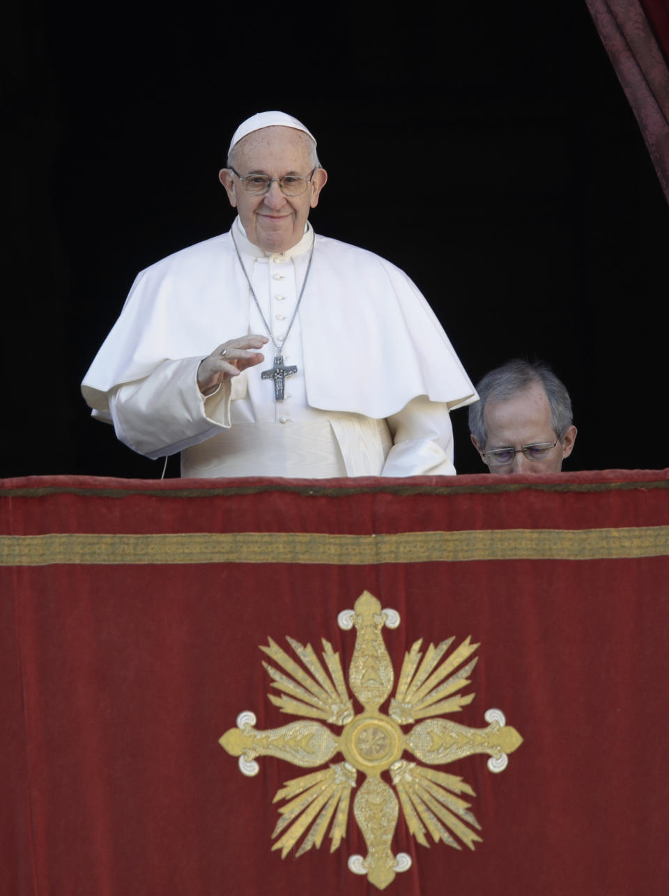 Pope Francis, flanked at right by Master of Ceremonies Bishop Guido Marini, arrives to deliver the Urbi et Orbi (Latin for 'to the city and to the world' ) Christmas' day blessing from the main balcony of St. Peter's Basilica at the Vatican, Tuesday, Dec. 25, 2018. (AP Photo/Alessandra Tarantino)