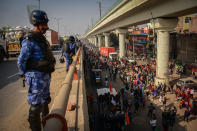 DELHI, INDIA - 2021/01/26: A policeman looks on as protesters take part in demonstration. Farmers protesting against agricultural reforms breached barricades and clashed with police in the capital on the India's 72nd Republic Day. The police fired tear gas to restrain them, shortly after a convoy of tractors trundled through the Delhi's outskirts. (Photo by Manish Rajput/SOPA Images/LightRocket via Getty Images)