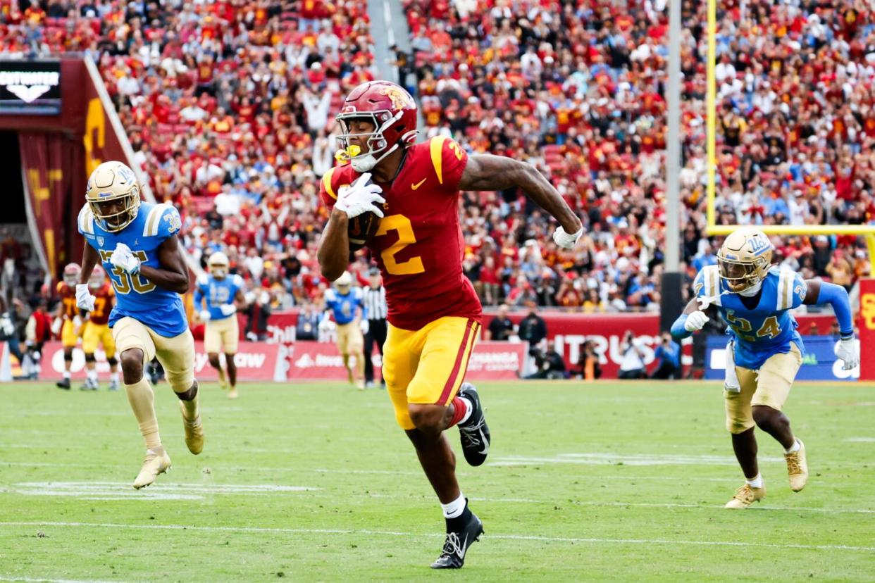 USC receiver Brenden Rice (2) runs past the UCLA defense for a 74-yard touchdown reception.