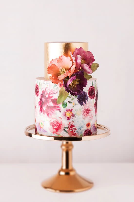 The combination of the simplistic gold top tier with the multi-coloured flowers painted onto the bottom cake make this bake a winner in our eyes. 