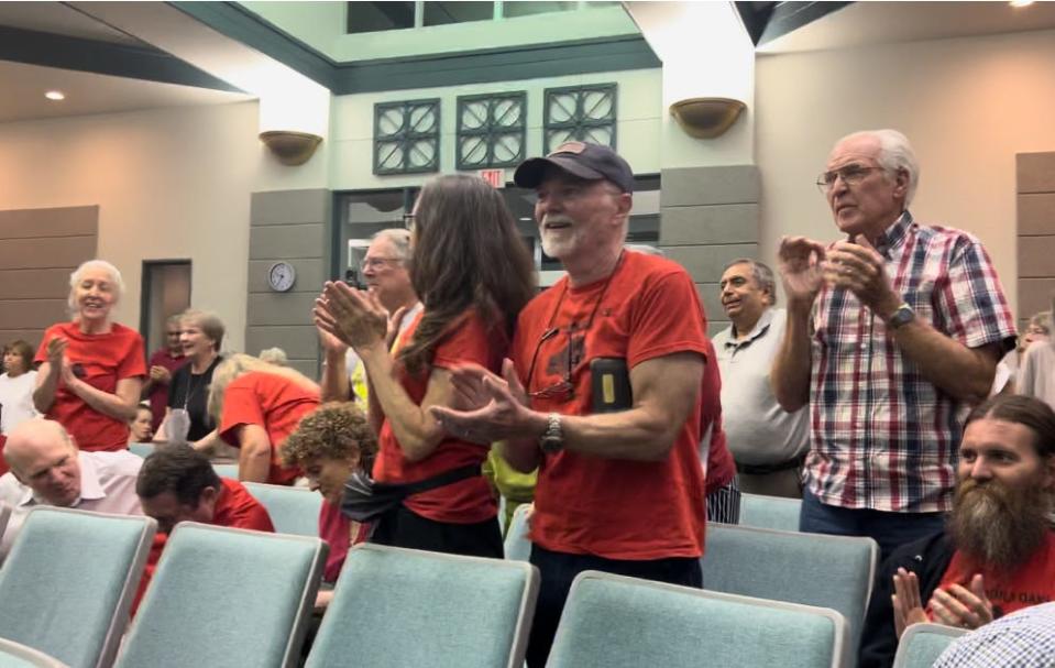 Residents of Ormond Beach's Tomoka Oaks community applaud the City Commission's unanimous decision to reject developers' zoning map amendment request to designate the subdivision's former golf course as 