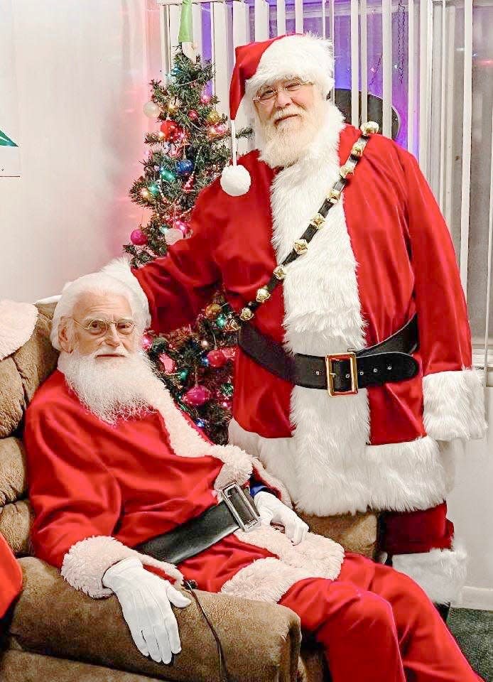 Floyd "Bud" Kline, left, was Hagerstown's resident Santa for 57 years. He recently passed the mantle to Chris Brezler, right. Kline died Saturday at 86.