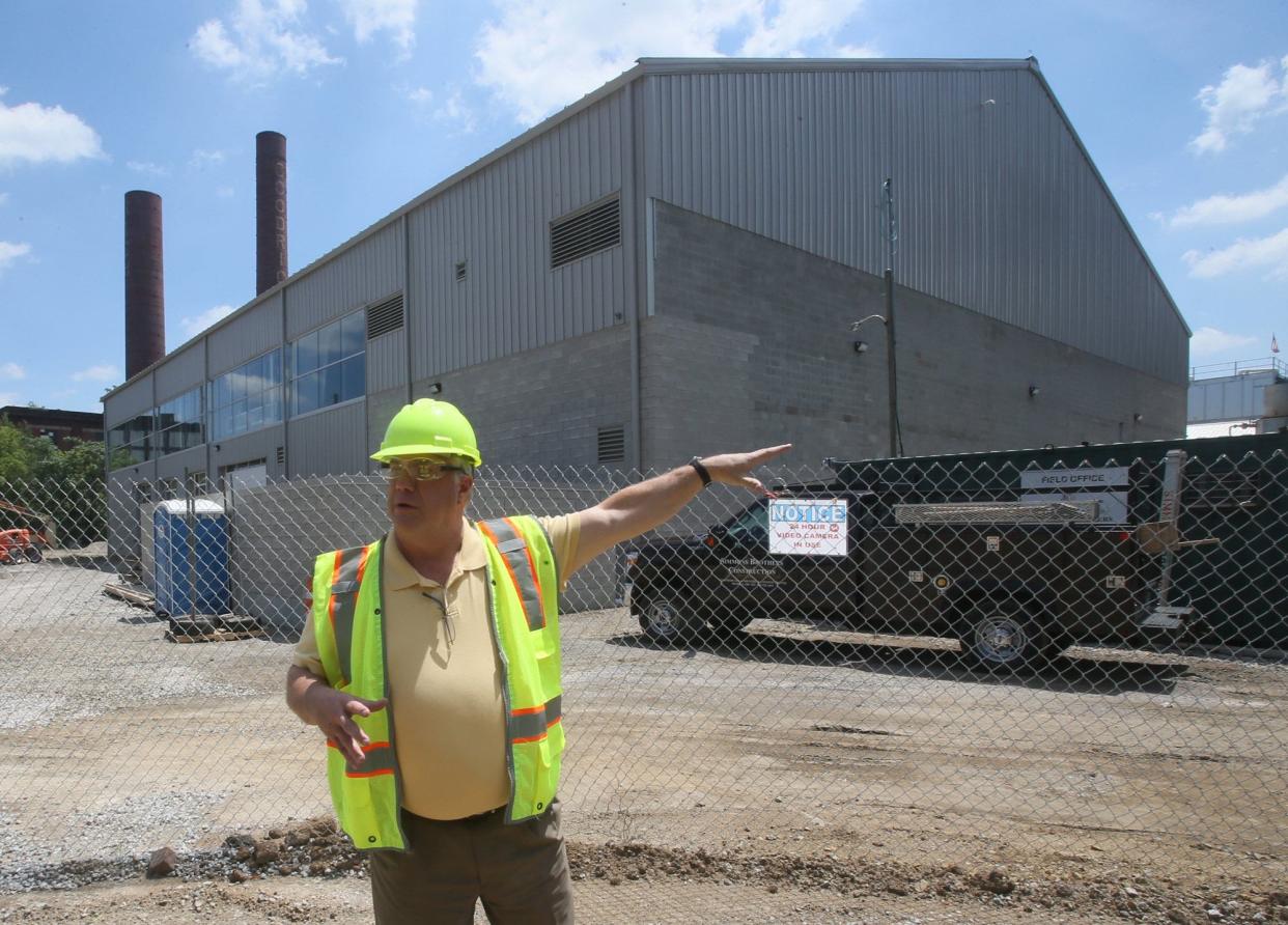 Kelly Dodson, marketing and sales manager at Akron Energy Systems, talks about the steam plant under construction in 2018 at 222 Opportunity Parkway.