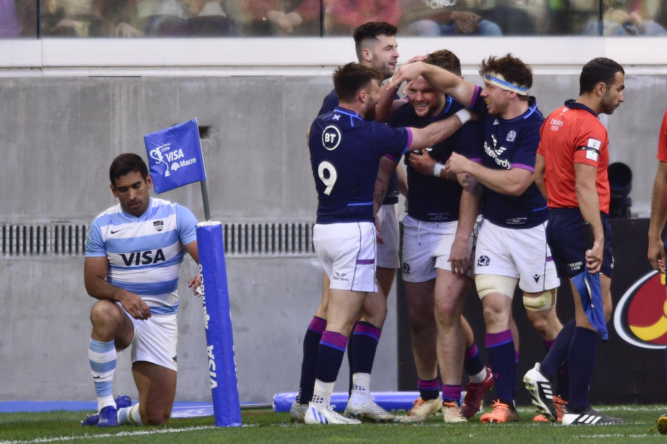 Scotland's David Cherry, center right, celebrates a try with the teammates during a rugby test match against Argentina, in Santiago Del Estero, Argentina, Saturday, July 16, 2022. (AP Photo/Gustavo Garello)