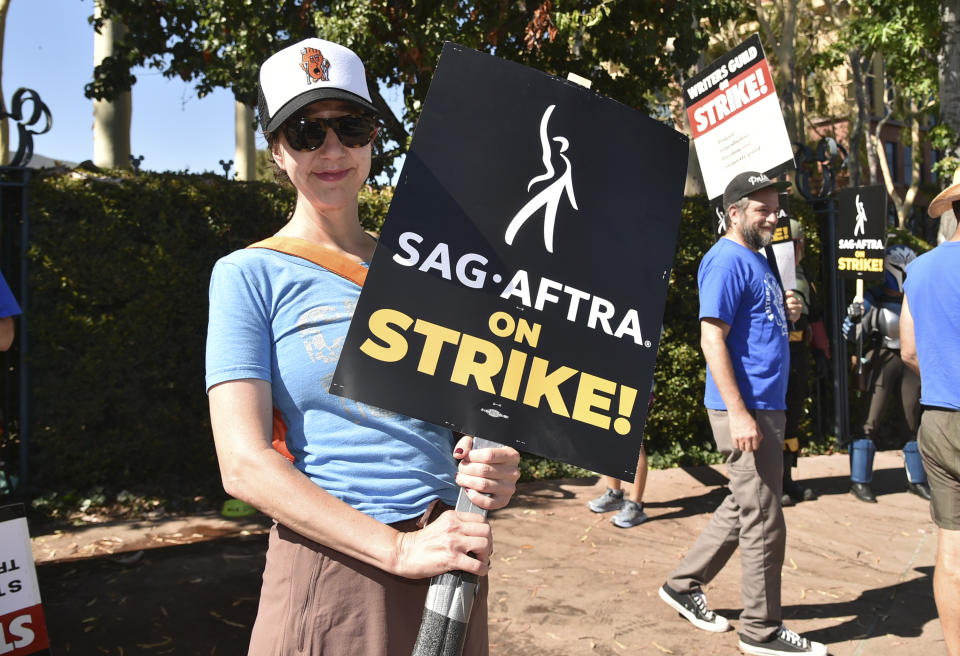 Kristen Schaal holds a sign on a picket line outside Disney studios on Thursday, July 20, 2023, in Burbank, Calif. The actors strike comes more than two months after screenwriters began striking in their bid to get better pay and working conditions. (Photo by Richard Shotwell/Invision/AP)