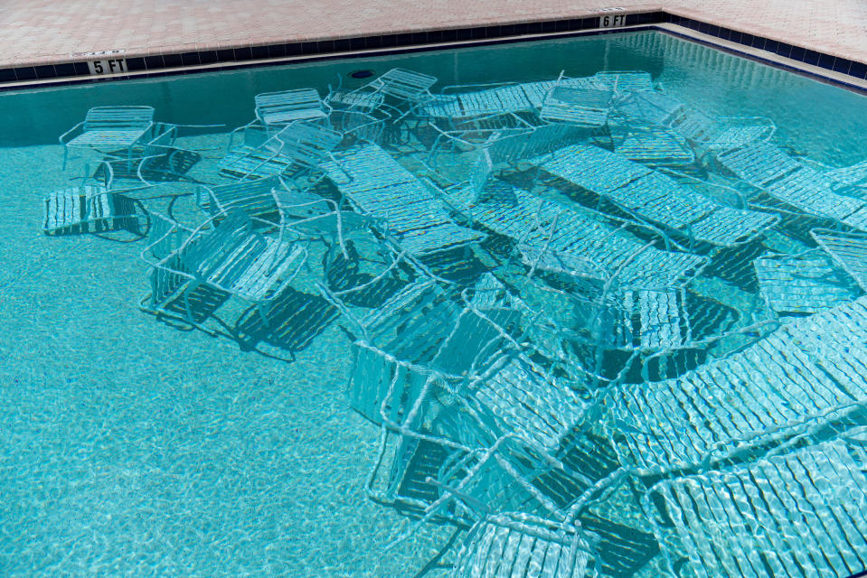 Pool chairs are stored under water in preparation for the arrival of Hurricane Ian at Harbourside Condominiums in South Pasadena, Fla. on Sept. 26.<span class="copyright">Martha Asencio-Rhine—Tampa Bay Times/ZUMA</span>