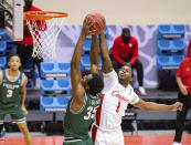 Houston guard Jamal Shead (1) attempts to block a shot by Cleveland State forward Deante Johnson (35) during the first half of a first-round game in the NCAA men's college basketball tournament, Friday, March 19, 2021, at Assembly Hall in Bloomington, Ind. (AP Photo/Doug McSchooler)