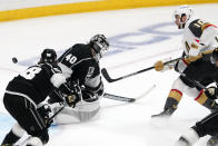 Vegas Golden Knights center Nicolas Roy, right, scores on Los Angeles Kings goaltender Calvin Petersen, center, as defenseman Kale Clague watches during the second period of an NHL hockey game Monday, April 12, 2021, in Los Angeles. (AP Photo/Mark J. Terrill)