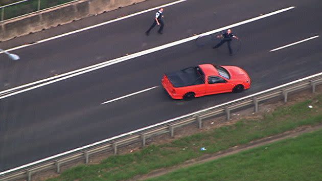 The driver swerves past police.