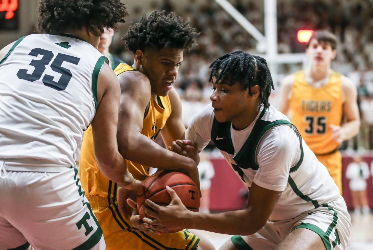 St. X's Jeremiah Jackson was pressured by Trinity guard Andrae Vasser, right and CJ Walls early in the first half of the Trinity-St.X basketball game Friday night at Knights Hall on Belleramine University campus. Jan. 6, 2023