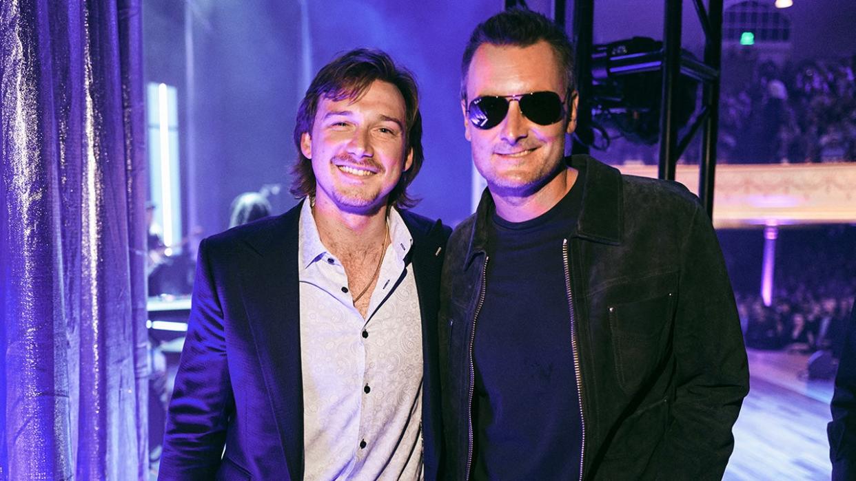 Country stars Morgan Wallen and Eric Church pose for photos after a concert.