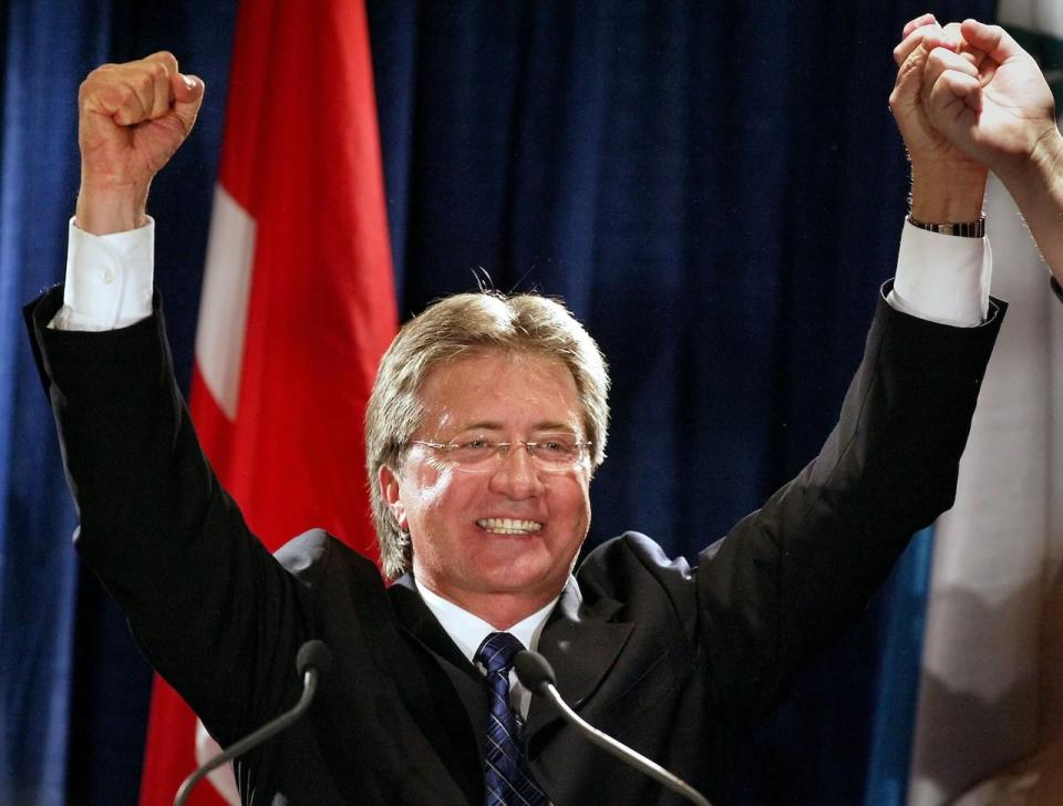 Danny Williams waves to supporters in Corner Brook after his party's victory in the 2003 provincial election. Williams was critical of Roger Grimes's decision to serve two and a half years as premier without calling an election. 