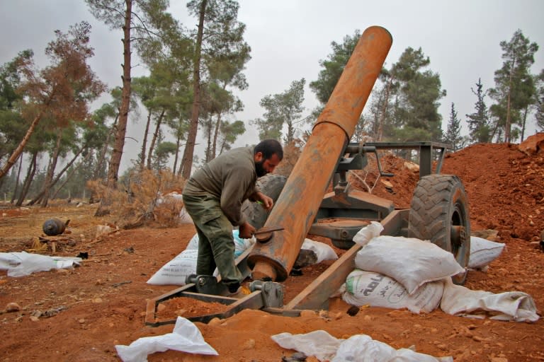 Rebel fighters from the Jaish al-Fatah (or Army of Conquest) prepare to fire a home-made mortar launcher during a major offensive against regime forces near Aleppo, on October 28, 2016