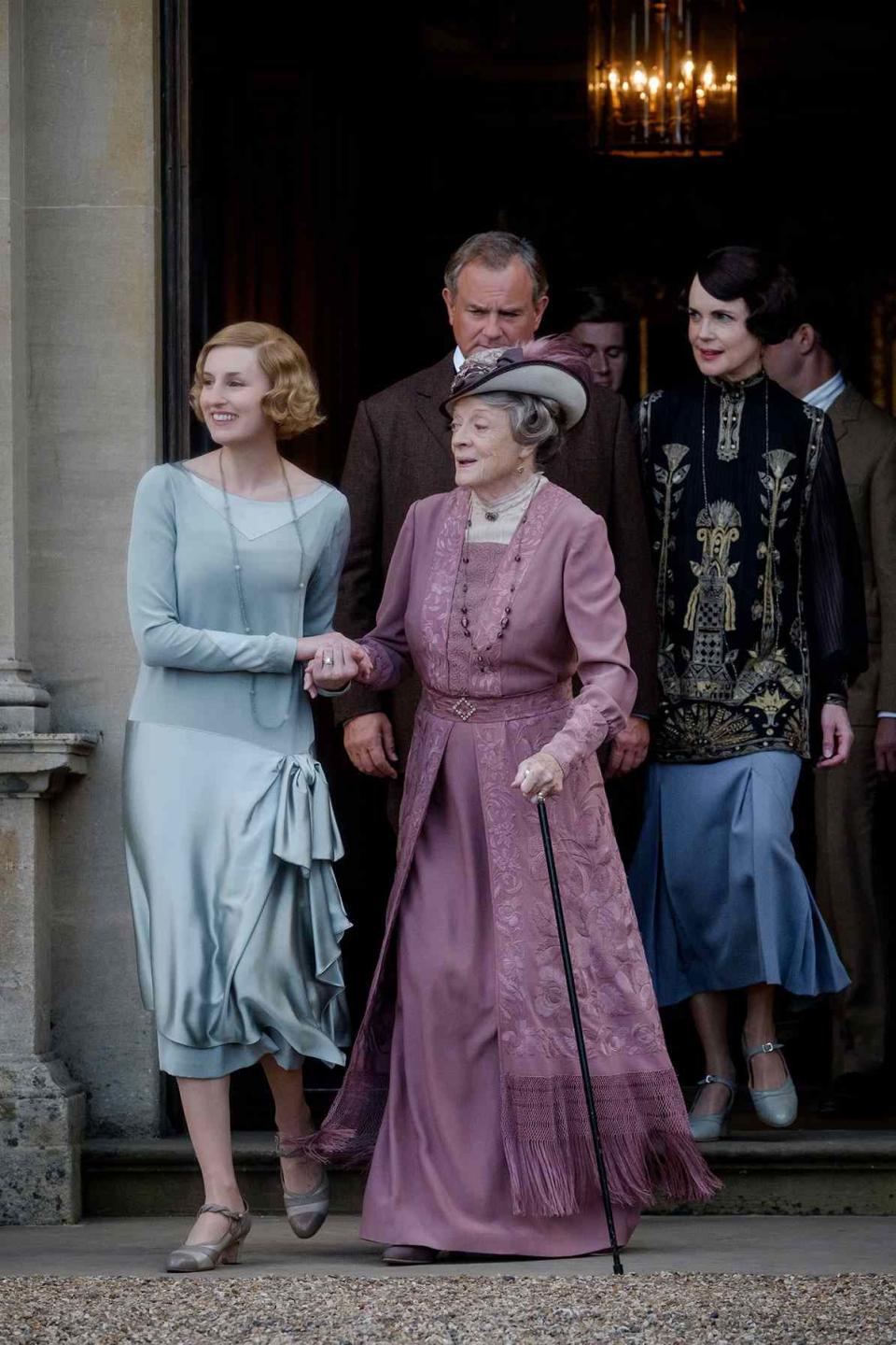 Cast of Downton Abbey exiting a building
