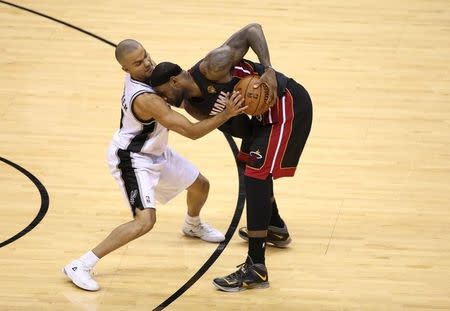 Miami Heat forward LeBron James (6) is defended by San Antonio Spurs guard Tony Parker (9) during the second half in game five of the 2014 NBA Finals at AT&T Center. Jun 15, 2014; San Antonio, TX, USA; Soobum Im-USA TODAY Sports