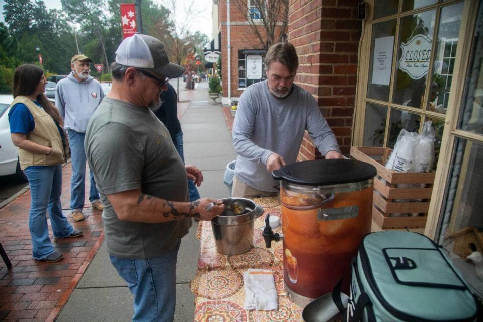 Robert Chanonat, left, and Sweet Basil Cafe owner John Davis serve free hot soup Wednesday Dec. 7, 2022 in Southern Pines shortly after power was restored. Two deliberate attacks on electrical substations in Moore County Saturday evening caused days-long power outages for tens of thousands of customers.
