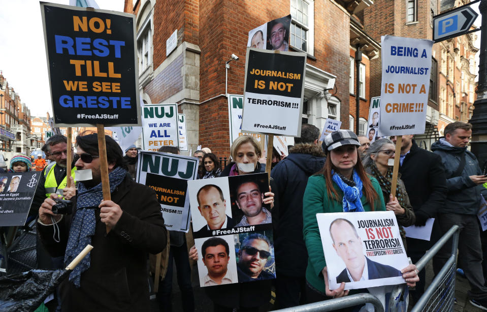 Journalists hold placards as they demonstrate across the street from Egypt's embassy in central London, Wednesday, Feb. 19, 2014. The protest organized by the National Union of Journalists called for the protection of journalists in Egypt, where six have been killed and many more injured covering events on the streets of Cairo and the rest of the country. Others, including Al-Jazeera English acting bureau chief in Cairo Mohammed Fahmy, a Canadian-Egyptian, award-winning correspondent Peter Greste of Australia and producer Baher Mohamed, an Egyptian have been imprisoned. (AP Photo/Lefteris Pitarakis)