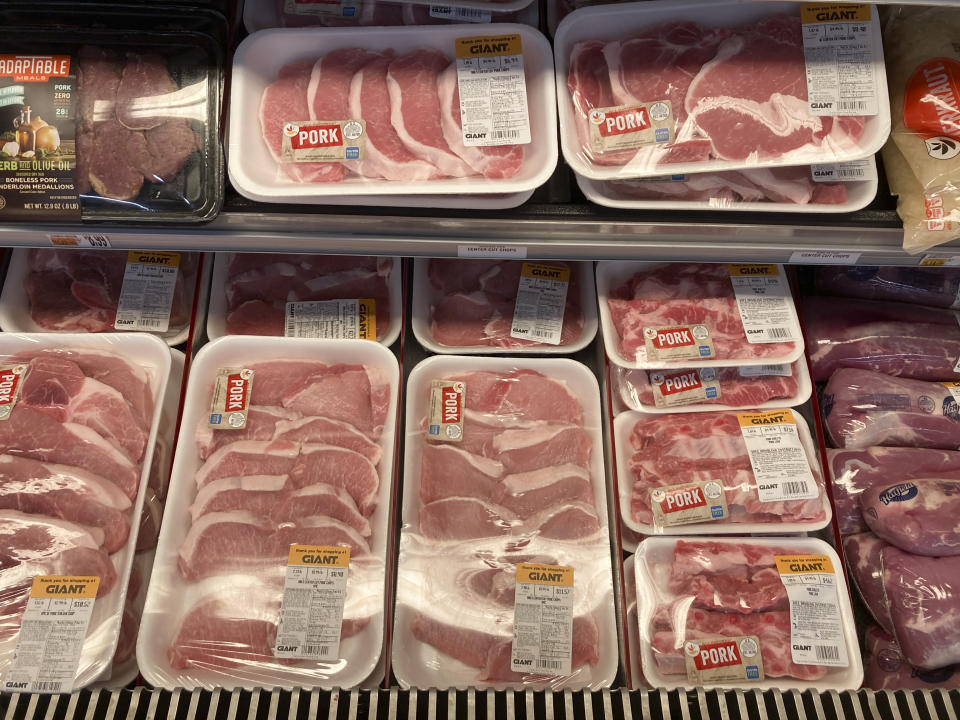 FILE - Pork products are seen at a grocery store in Roslyn, Pa., on June 15, 2021. American consumers and nearly every industry will be affected if freight trains grind to a halt in December 2022. Any disruption in rail service could threaten the health of chickens and pigs, which depend on trains to deliver their feed, and contribute to higher meat prices. (AP Photo/Matt Rourke, File)
