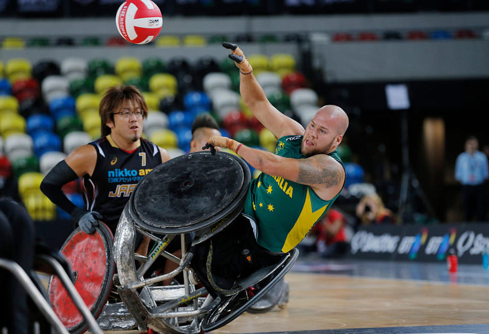 Australian player Ryley Batt passes while being upended by Japan's Daisuke Ikesaki during a match in the World Wheelchair rugby challenge at the Copper Box Arena, Queen Elizabeth Olympic Park on October 13th 2015 in London. (Photo by Tom Jenkins)