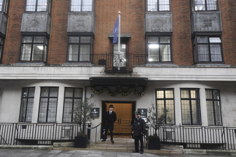 Police and hospital personnel outside King Edward VII's Hospital, in London, Friday, Dec. 20, 2019. Prince Philip, husband of Queen Elizabeth II, has been admitted to a London hospital “as a precautionary measure,” Buckingham Palace said Friday. The palace said in a statement the 98-year-old Philip was admitted to the King Edward VII hospital for observation and treatment of a pre-existing condition. (Victoria Jones/PA via AP)