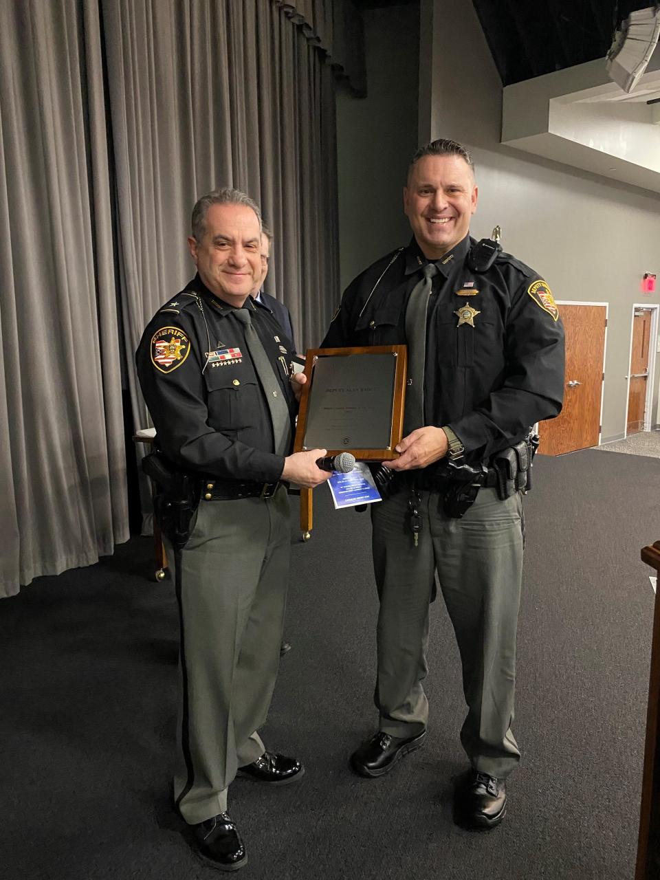 Stark County Sheriff George Maier, left, stands with Deputy Alan Raber, who was named Stark County Deputy of the Year on Wednesday at the Crime Prevention Breakfast sponsored by the Exchange Club of Canton-Stark County.