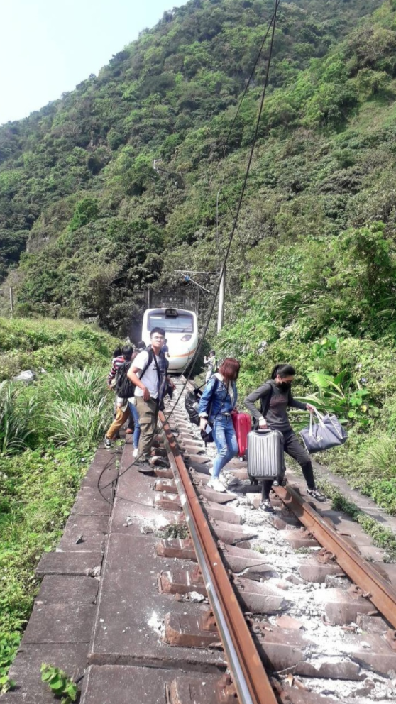 旅客倉皇從列車上破窗逃生。（翻攝畫面）