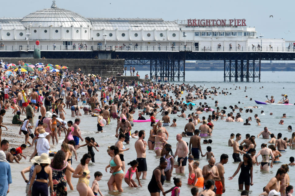 People enjoy the sunny weather on the beach, amid the coronavirus disease (COVID-19) outbreak, in Brighton, Britain August 8, 2020. REUTERS/Toby Melville     TPX IMAGES OF THE DAY