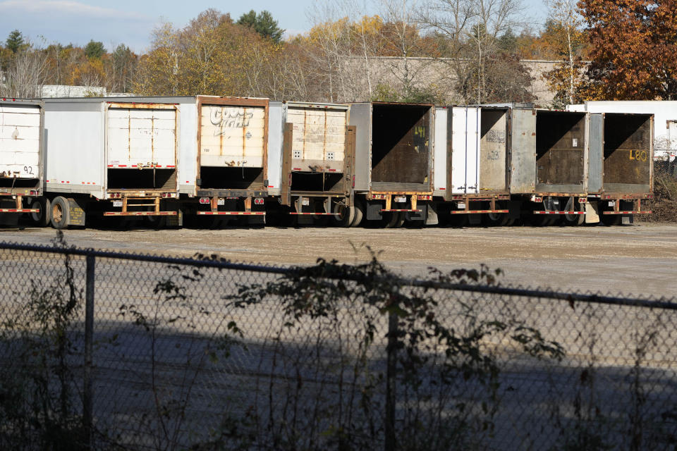 Trailers are seen in a parking lot at a recycling facility where law enforcement found the body of Robert Card, the suspect in this week's mass shootings, Saturday, Oct. 28, 2023, in Lisbon Falls, Maine. Card was wanted for the shooting deaths of 18 people at a bowling alley and a bar in Lewiston, Maine on Wednesday. (AP Photo/Robert F. Bukaty)