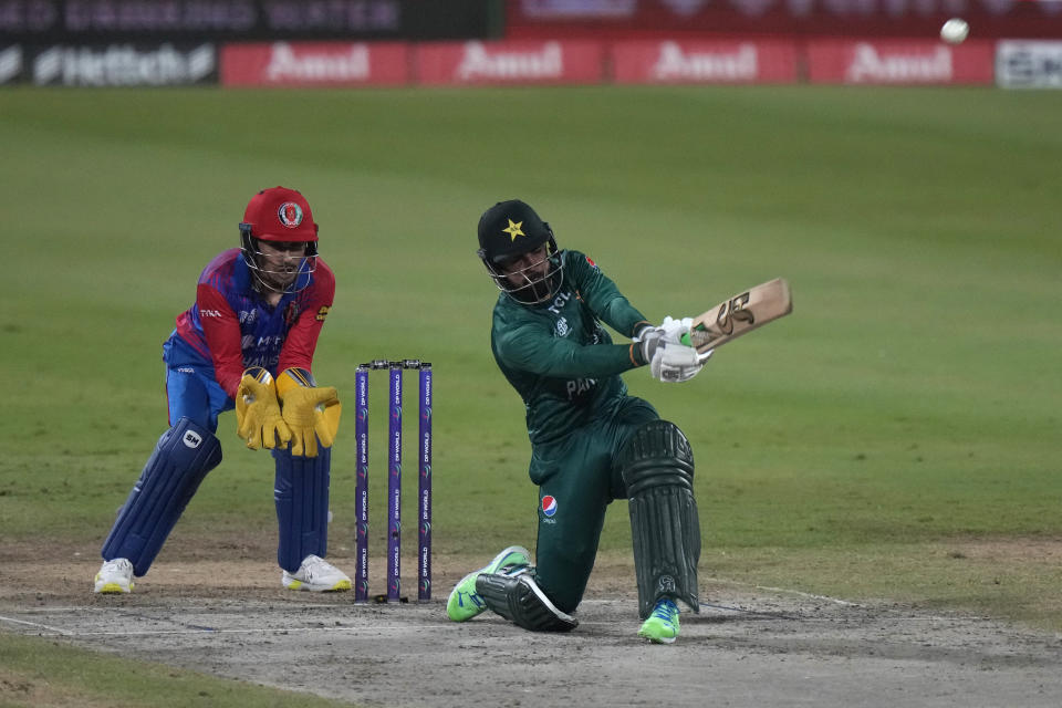 Pakistan's Shadab Khan, right, hits a boundary during the T20 cricket match of Asia Cup between Pakistan and Afghanistan, in Sharjah, United Arab Emirates, Wednesday, Sept. 7, 2022. (AP Photo/Anjum Naveed)