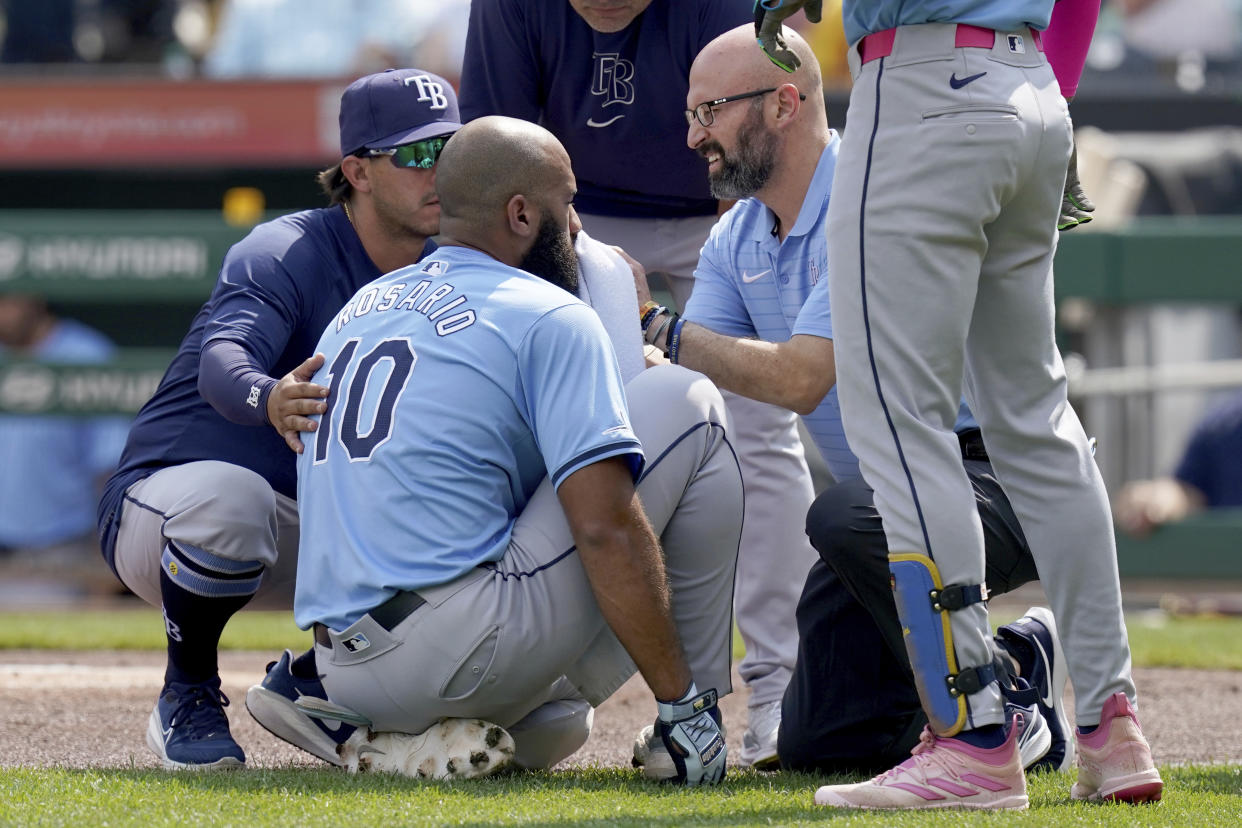 Tampa Bay Rays' Amed Rosario (10) is tended to after getting hit by a pitch from Pittsburgh Pirates starter Jared Jones during the first inning of a baseball game Saturday, June 22, 2024, in Pittsburgh. (AP Photo/Matt Freed)