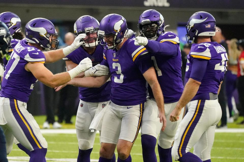 Minnesota Vikings punter Jordan Berry (3) is congratulated by teammates after a punt to the 1-yard-line to the Seattle Seahawks in the second half of an NFL football game in Minneapolis, Sunday, Sept. 26, 2021. (AP Photo/Jim Mone)