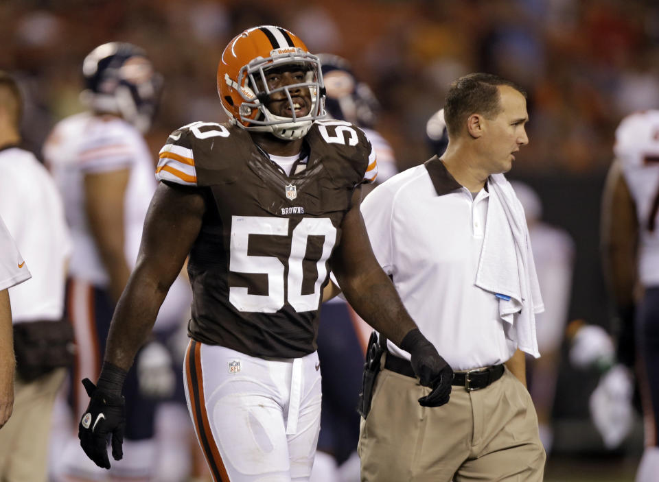 FILE - In this Aug. 30, 2012, file photo, Cleveland Browns linebacker James-Michael Johnson (50) leaves a preseason NFL football game against the Chicago Bears with an injury in Cleveland. Johnson, a linebacker, retired at age 27 after getting cut seven times by six teams over four seasons. (AP Photo/Mark Duncan, File)