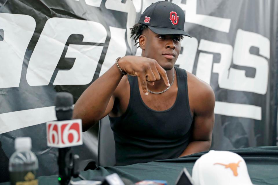 Tulsa Noah senior defensive end Danny Okoye gives a horns down as he announces his commitment to OU on Sept. 20 in Bixby.