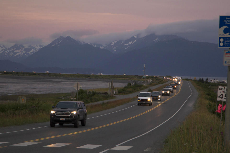 A line of cars evacuates the Homer Spit in Homer, Alaska on July 28, 2021, after a tsunami warning was issued following a magnitude 8.2 earthquake.  / Credit: Sarah Knapp/Homer News via AP